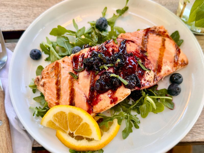 Blueberry Balsamic Glazed Salmon with fresh blueberries and basil.
