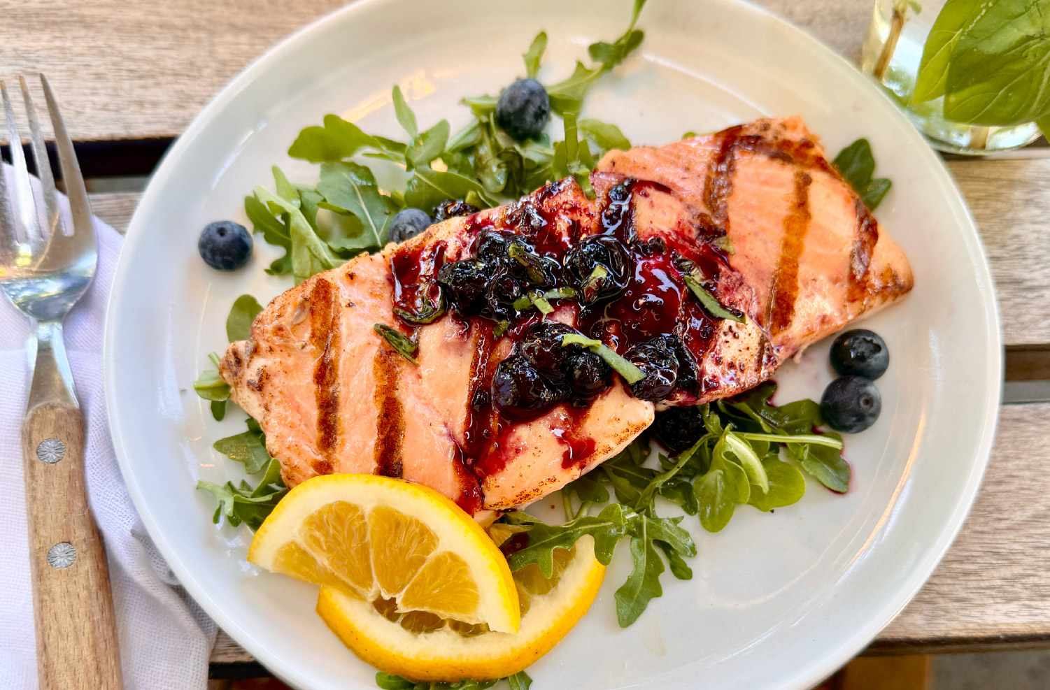 Blueberry Balsamic Glazed Salmon with fresh blueberries and basil.