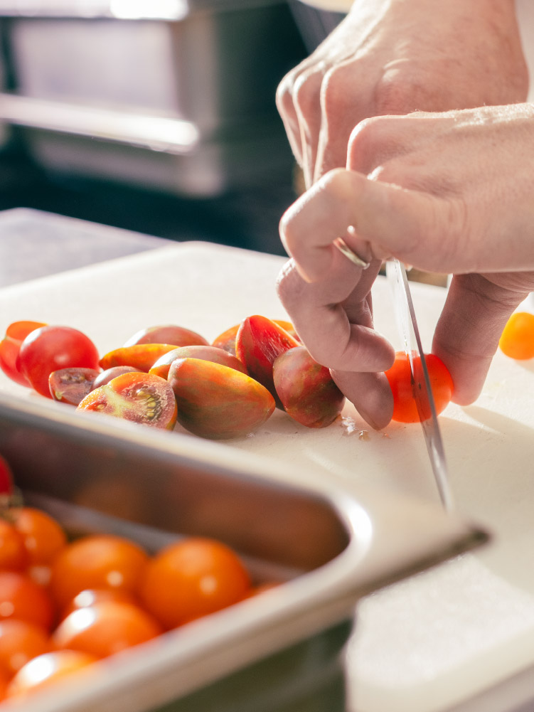 Chef Laura cutting up tomatoes