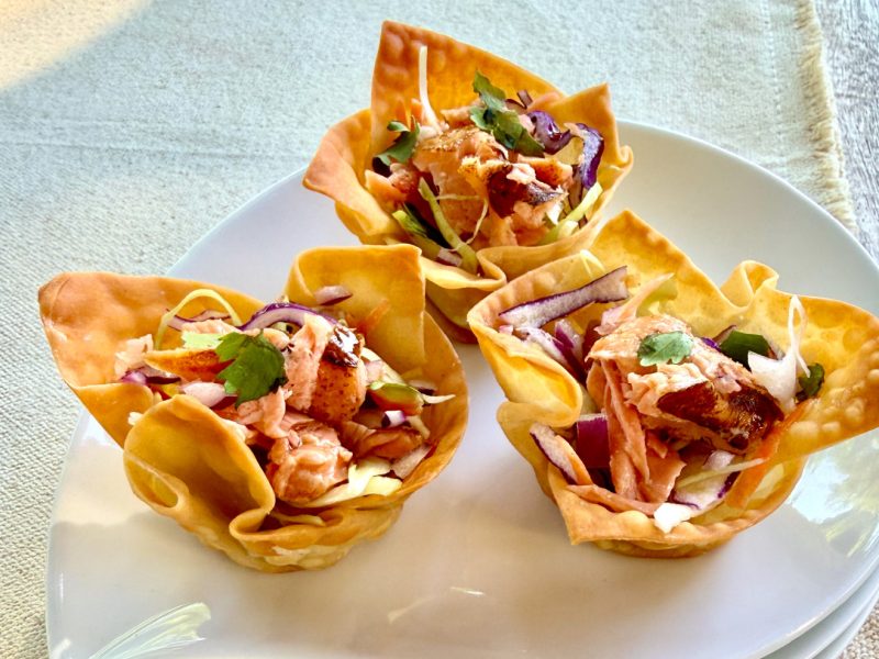 Crispy Salmon Cups made with California King Salmon, colorful slaw, and wonton wrappers served on a white plate.