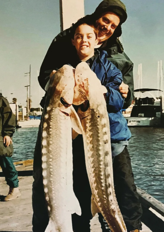 Tim and his father holding fish