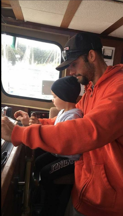 Tim and his son running a boat